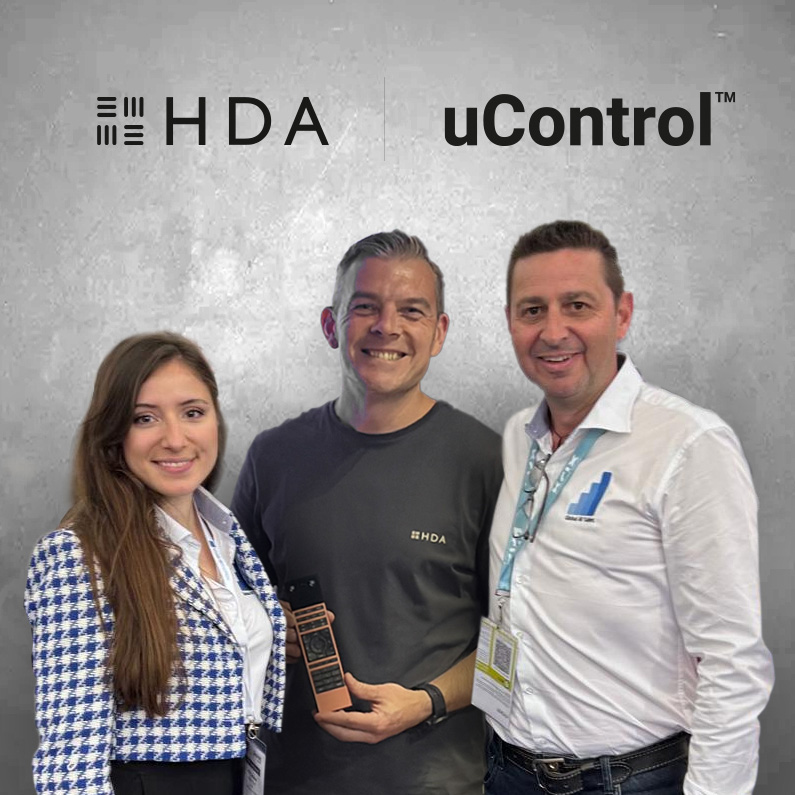 Micaela Corcimari, Chris Pinder and Dave Williams posing with a uControl Remote